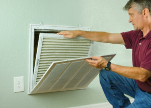 man replacing air filter